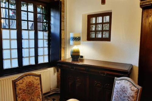a room with a desk with a lamp and two chairs at MAISON DE NOSTRADAMUS*** OCCITANIE INSOLITE in Alet-les-Bains