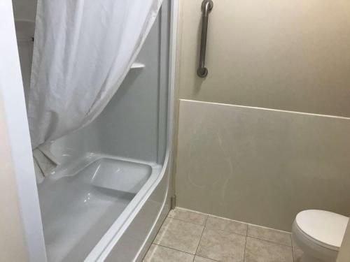 a bathroom with a shower and a toilet at Best Western Thunder Bay Crossroads in Thunder Bay