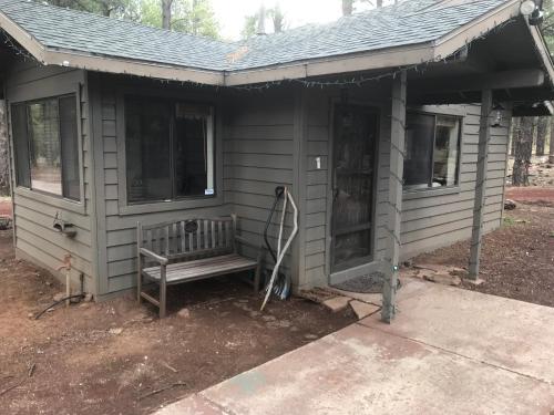 a house being constructed with a bench in front of it at Grand Canyon Cottage at Historic Wrigley Ranch with Horseback Riding & Hiking in Parks