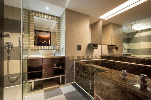 a large bathroom with a sink and a shower at Taipei Lotty Hotel in Taipei