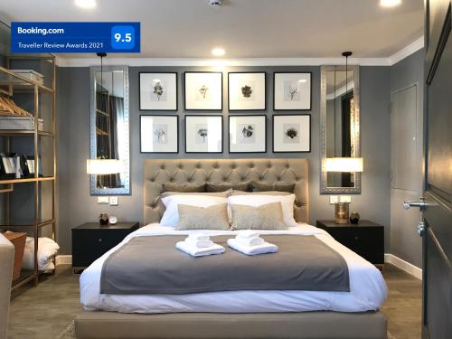 a bedroom with a large bed with two towels on it at Stay in Style at Nimman R306A in Chiang Mai