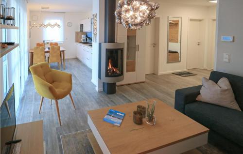a living room with a couch and a fireplace at 2 Bedroom Cozy Apartment In Rechlin in Rechlin