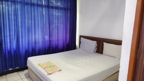 Llit o llits en una habitació de De' Premium Hotel Musi Raya