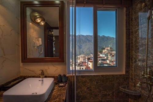 a bathroom with a sink and a window at Sapa Horizon Hotel in Sa Pa