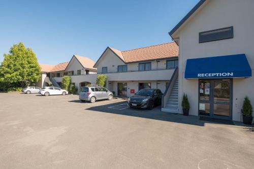 a parking lot in front of a hotel with cars parked at Bella Vista Nelson in Nelson