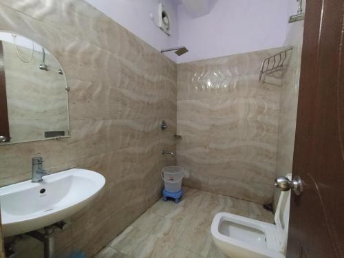 a bathroom with a sink and a toilet at Hotel The Super Mall Residency, Mussoorie in Mussoorie