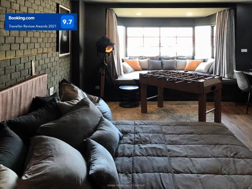 a living room with a couch and a table at Stay in Style at Nimman R911 in Chiang Mai