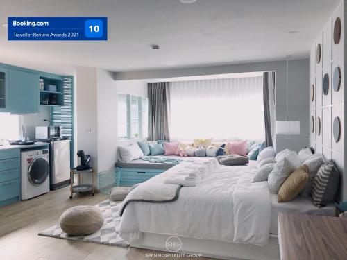 a bedroom with a large bed and a large window at Stay in Style at Nimman R918 in Chiang Mai