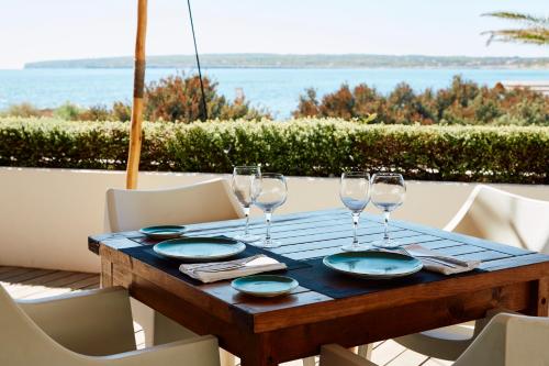 
a dining room table with two chairs and two plates of food at Insotel Hotel Formentera Playa in Playa Migjorn

