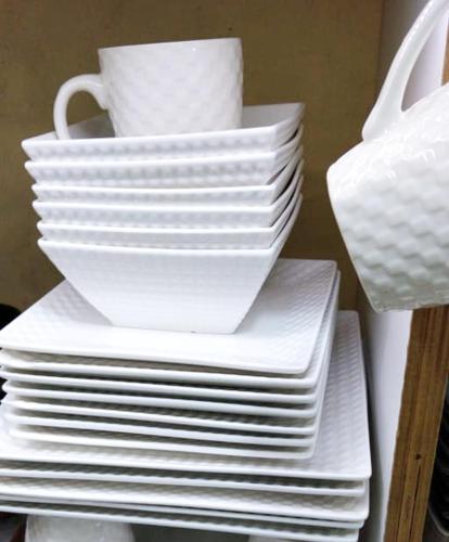 a stack of white plates and cups on a shelf at Sofitel Executive 4 bedrooms stand alone Milimani in Kisumu
