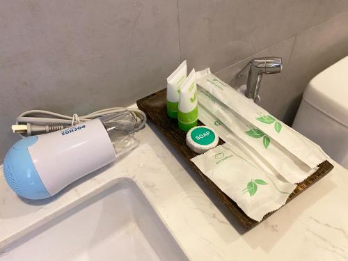 a hair dryer on a tray next to a toilet at SS Hotel & Residence in Sihanoukville