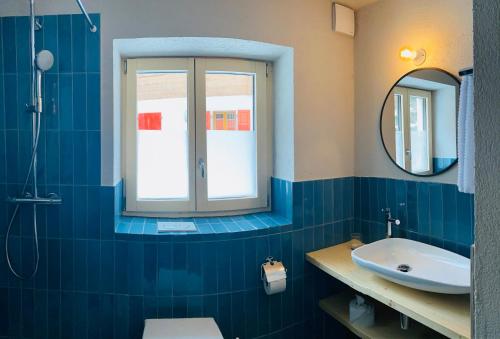 a bathroom with a sink and a mirror at Chalet Bergheimat Zermatt in Zermatt