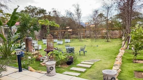 a garden with a playground with tables and chairs at Alice’s Home in Jinsha