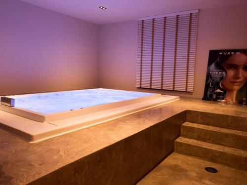 a large hot tub in a room with stairs at Chateau d'Urspelt in Urspelt