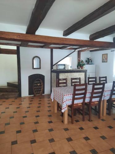 a dining room with a table and chairs and a fireplace at Casa Maria in Vatra Dornei