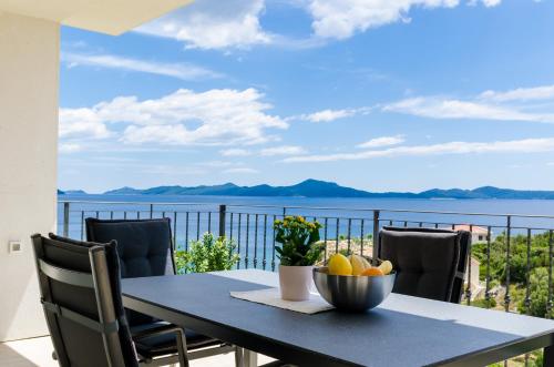 a table with a bowl of fruit on a balcony at Villa Sofija Dubrovnik & Peljesac Region in Slano