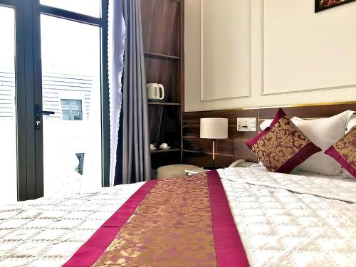 a bedroom with a bed and a large window at NEW CITY HOTEL in Tây Ninh
