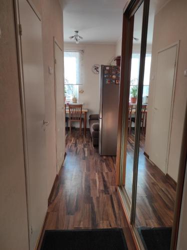 a hallway with a refrigerator and a dining room at NarvaCenter in Narva