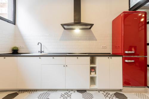 a kitchen with white cabinets and a red refrigerator at Ever House - ALCALA LOFT in Madrid