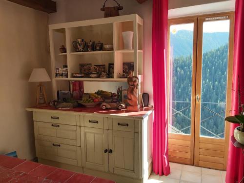 a kitchen with a sink and a window at B&B Le Rupicapra in Roubion