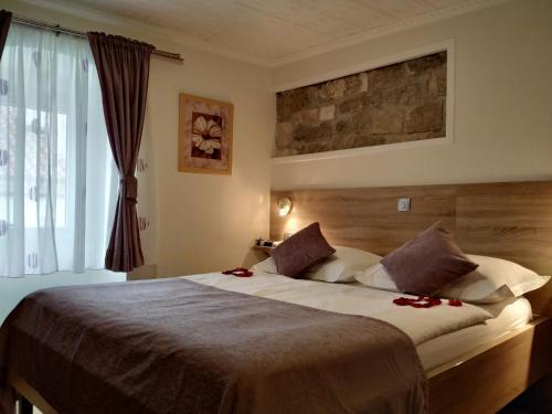 a bedroom with a large bed and a window at Hotel Kastel 1700 in Split