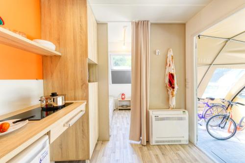 a kitchen with a bike parked next to a window at San Benedetto Camping Relais in Peschiera del Garda