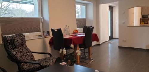 Un comedor con una mesa y sillas rojas. en Souterrainwohnung im Grünen, en Witten
