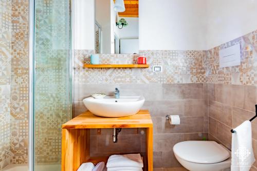 a bathroom with a sink and a toilet at Beach Front Villas in Calabernardo