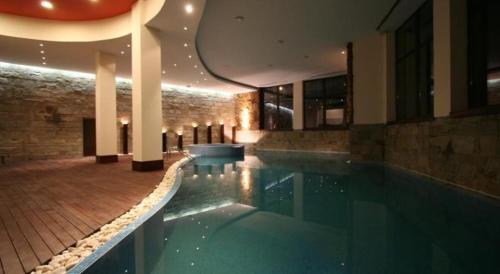 a large swimming pool in a building with a building at Апартамент в комплекс Bansko Royal Towers in Bansko