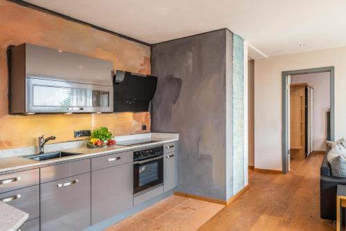 a kitchen with a sink and a stove at Lebensart am See in Bad Endorf