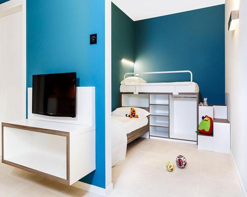 a small room with a bed and a tv at Golfo del Sole Hotel & Holiday Resort in Follonica