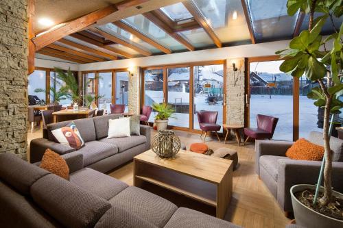 a living room with couches and a table at Alzbeta resort - Aqua & Wellness in Liptovský Mikuláš