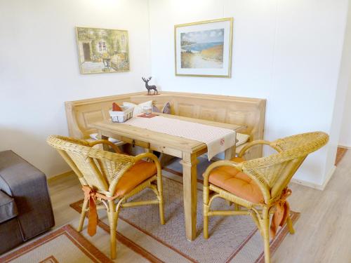 a dining room with a table and two chairs at Landhaus Sonnenblick in Reit im Winkl