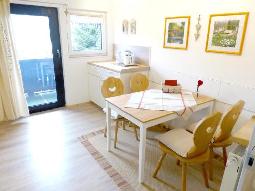 a kitchen with a table and chairs in a room at Landhaus Sonnenblick in Reit im Winkl