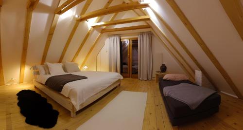 a bedroom with a large bed in a attic at 4Badgers / 4Jazavca - Mountain House in Kopaonik