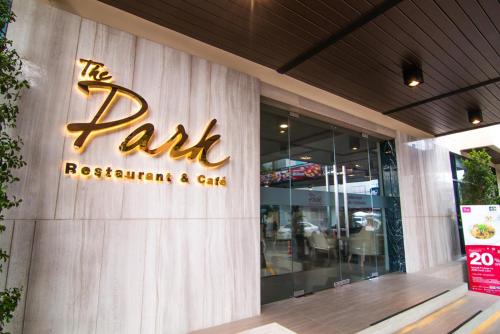 a restaurant sign on the side of a building at Pacific Park Hotel in Si Racha