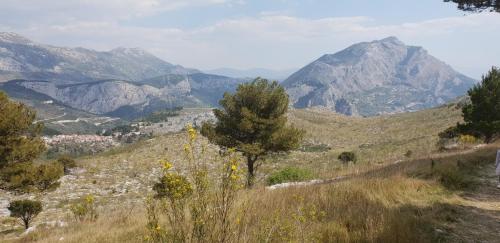 a view of a hill with mountains in the background at Cozy apartments with seafront terraces in Omiš