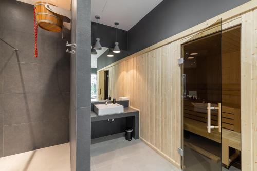 a bathroom with a sink and a mirror at Apartment Antonio in Gdańsk