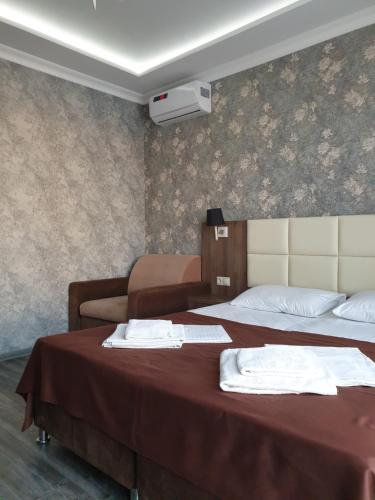  Кровать или кровати в номере Bumerang Hotel 