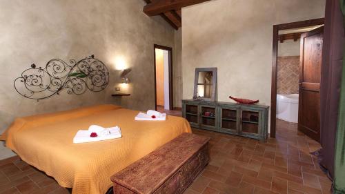 a bedroom with a bed and a sink and a tub at GENIUS LOCI 6, Emma Villas in Collazzone