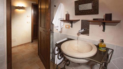 a bathroom with a sink in a room at GENIUS LOCI 6, Emma Villas in Collazzone