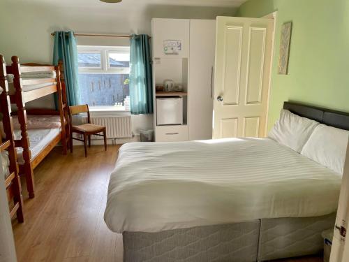 a bedroom with a bed and two bunk beds at An Stór Townhouse in Midleton