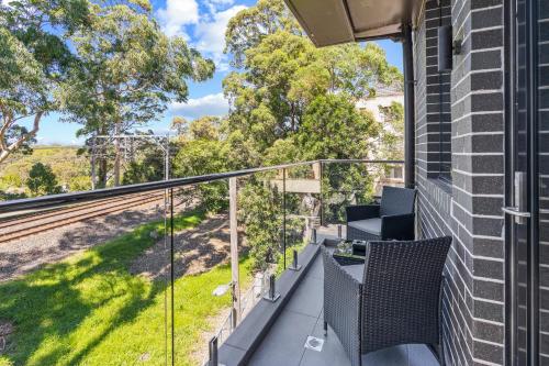 a balcony with a table and chairs on a house at Seranin | Gordon in Pymble