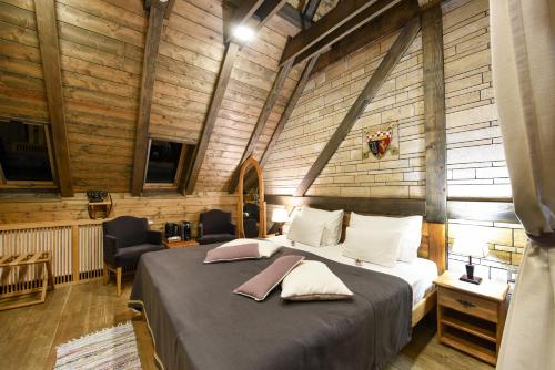 a bedroom with a bed with two pillows on it at Ethno Houses Plitvice Lakes Hotel in Plitvica selo