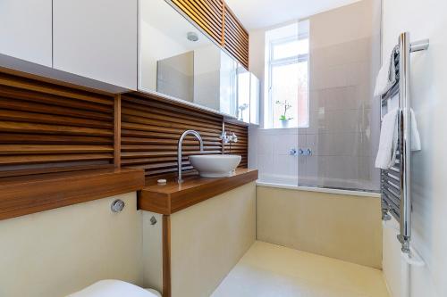 a bathroom with a sink and a shower at Holborn City Living in London