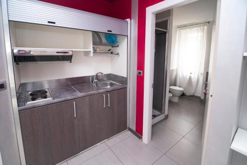 a small kitchen with a sink and a toilet at Residence Le Betulle Executive in Caselette