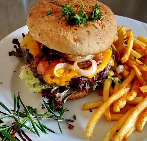 a sandwich and french fries on a white plate at Landhaus Gräfendhron in Gräfendhron