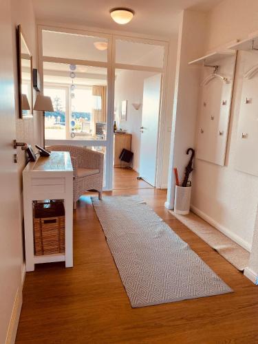 a living room with a table and a rug at Haus Halligblick Whg 20 in Wyk auf Föhr