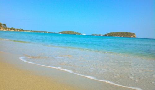 a beach with blue water and islands in the background at Blue Horizon Boutique Resort in Vieques