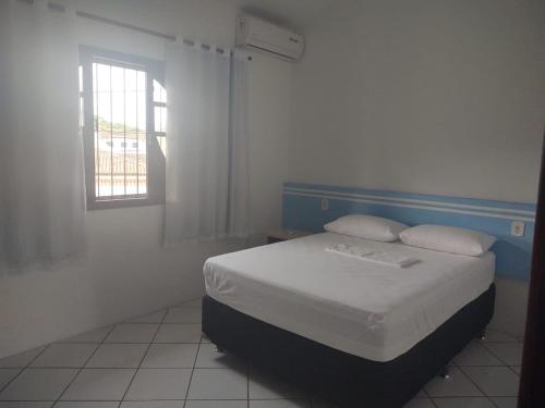 Säng eller sängar i ett rum på Apto em Porto Seguro - Centro